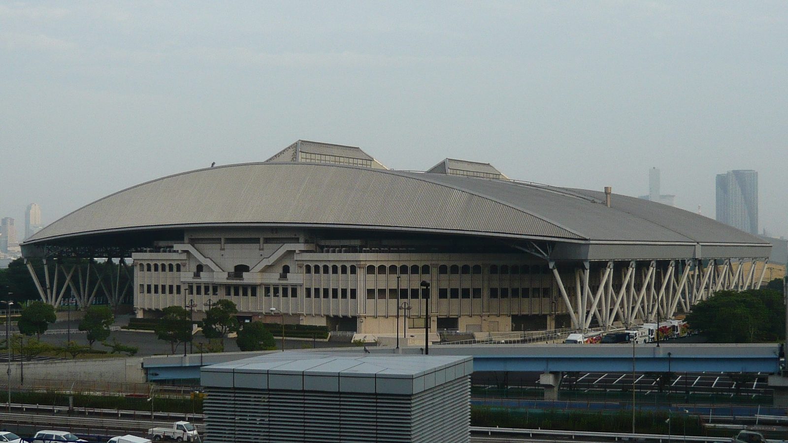 Exterior of Ariake Colosseum in Tokyo viewed across the surrounding roads